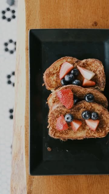 Berry-topped pastry on a black plate