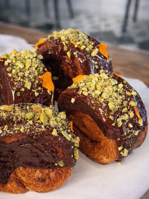 Pistachio-topped chocolate eclairs
